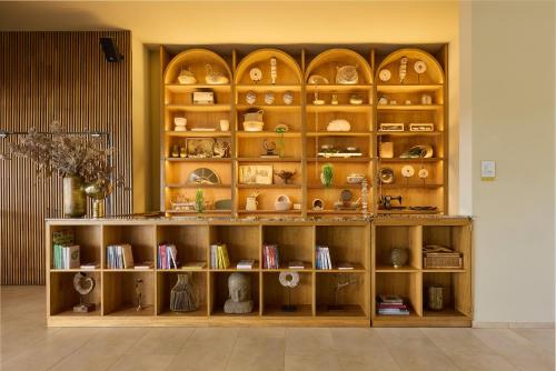 a wooden shelf with dishes and other items on it at Tau House in Guatapé