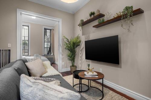 a living room with a couch and a flat screen tv at Sophisticated Stay in Vibrant Manhattan in New York