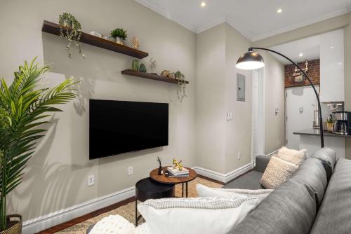 a living room with a couch and a flat screen tv at Sophisticated Stay in Vibrant Manhattan in New York