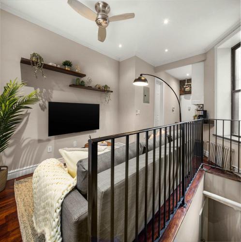 a living room with a couch and a flat screen tv at Sophisticated Stay in Vibrant Manhattan in New York