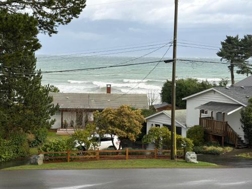 a house with the ocean in the background at Large ocean view family retreat in Comox