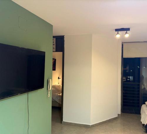 a living room with a flat screen tv on a wall at Dpto en la costa in Villa María