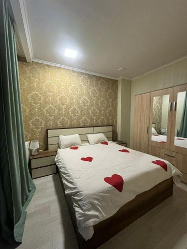 a bedroom with a bed with red hearts on it at City View Apartments At Dadiani St in Tbilisi City