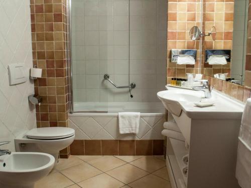a bathroom with a toilet and a sink and a shower at JR Resort Elba International in Capoliveri