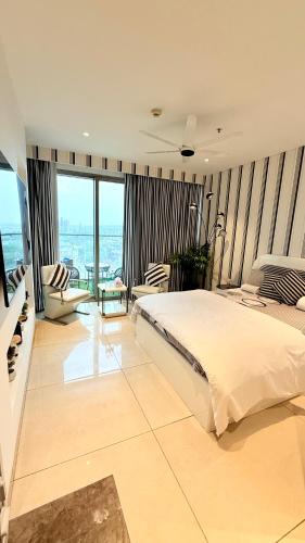 a bedroom with a large bed and a large window at Zebra Luxe Loft Studio with patio in Gurgaon