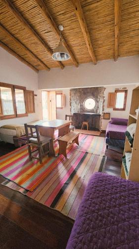 a living room with a table and a couch at ETERNO SOL Loft Andino in Humahuaca