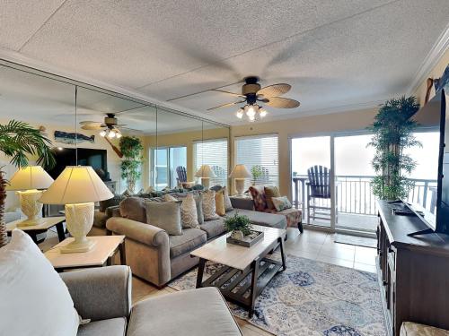 a living room with couches and tables and a ceiling fan at Island Echos #3K in Fort Walton Beach