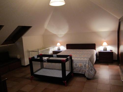 a bedroom with a bed and two lamps and a staircase at Penthouse Marina Sol in Madalena do Mar