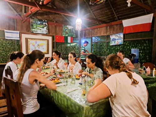 a group of people sitting at a table in a restaurant at Jacamar Lodge Expeditions in Iquitos