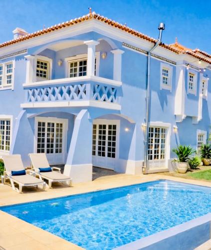 a house with a swimming pool in front of it at Ericeira -Oceonview Villa with Pool and Whirlpool in Ericeira