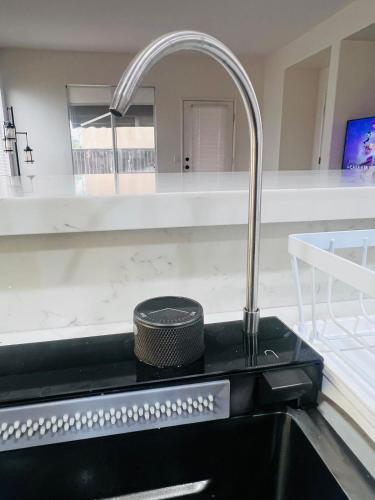 a kitchen sink with a faucet on a counter at Stylish & Fully Renovated Home! in Oxnard