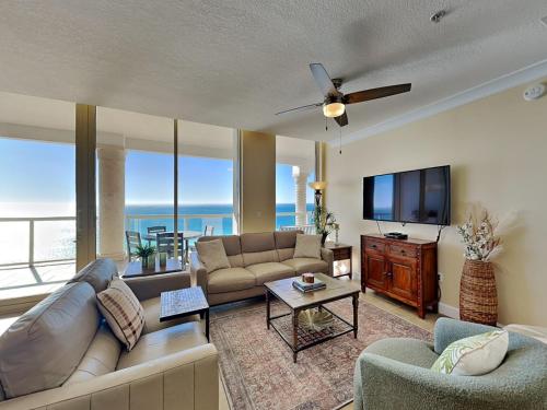 a living room with a couch and a flat screen tv at Beach Club #1605C in Pensacola Beach