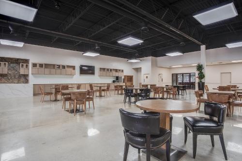 a dining room with tables and chairs in a building at Clarks Inn Savannah Airport in Pooler