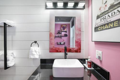 a bathroom with a white toilet and a pink wall at Lakefront Couples Retreat in the Poconos in Saylorsburg