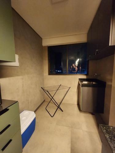 a small bathroom with a toilet and a window at Apartamento Edifíco Prestige in Marechal Deodoro