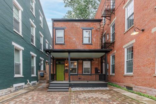 a building with a green door in between two buildings at Velvet Haus Downtown 3rd Floor Deck Backyard in Cincinnati