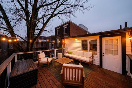 a deck with a couch and a bench on a house at Velvet Haus Downtown 3rd Floor Deck Backyard in Cincinnati