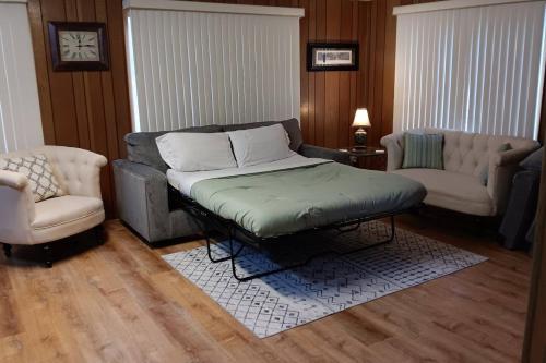 a living room with a couch and two chairs at Cozy Cabin in Packwood in Randle