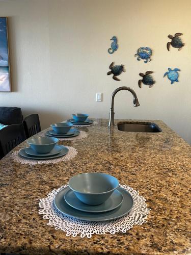 a kitchen counter with four bowls and a sink at This could be your view every night of your stay!! Cozy, comfy remodeled condo! in Tampa