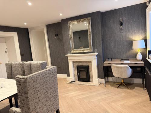 a living room with a desk and a fireplace at Luxury Croft Templepatrick Near Airport Rabbit and Hilton hotel in Templepatrick