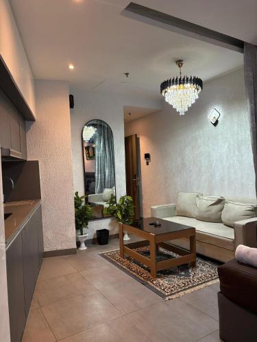 a living room with a couch and a table at Spira staycation in New Delhi