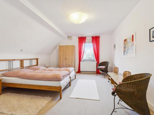 a bedroom with a bed and a desk and a chair at Schwermann in Schmallenberg