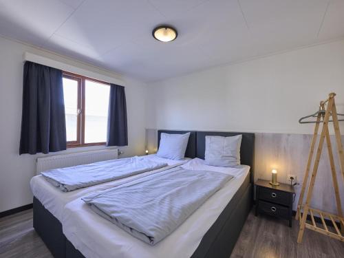 a large bed in a room with a ladder at t Kaatsheuveltje 7 in Kaatsheuvel