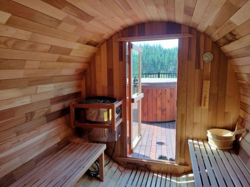 an inside view of a wooden cabin with a stove at Redwood Valley B & B in Richmond