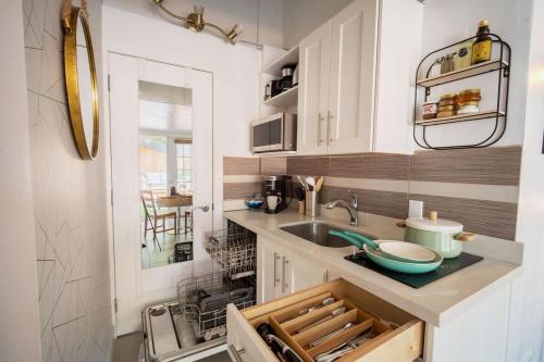 a kitchen with white cabinets and a sink at King Garden Suite/20 mins to Dwntwn Vancouvr/PetOk in North Vancouver
