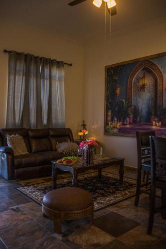 a living room with a couch and a table at Villas Persas by Jardin de Persia in Valle de Guadalupe