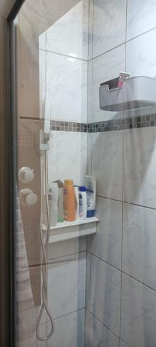 a bathroom with a shelf with cups on it at Chambre double avec lit clic clac in Saint-Pardoux-Isaac