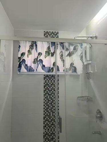a bathroom with a shower with a shower curtain at M&Js Place in Cebu City