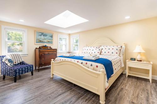a bedroom with a bed and a chair at Cape Seacret in South Yarmouth