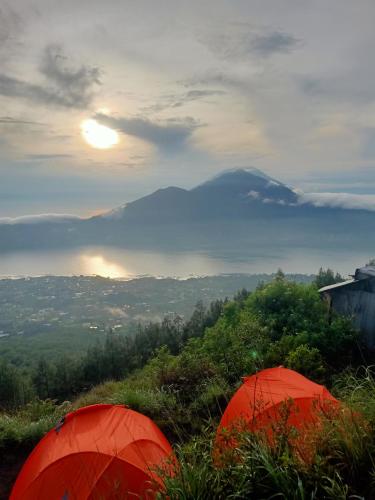 two tents on a hill with a view of a mountain at Batur Sunrise Tent in Kubupenlokan