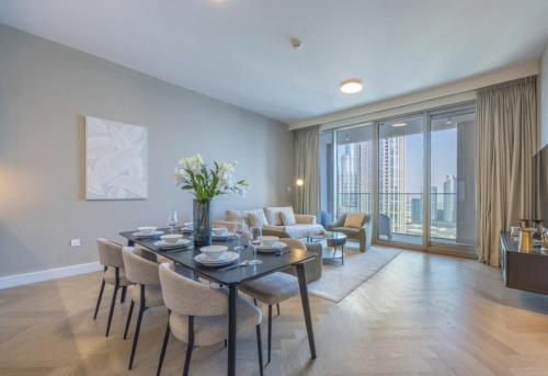 a dining room with a table and chairs in a living room at Private Room in Downtown Burj Vista Apartment with Burj Khalifa View in Dubai