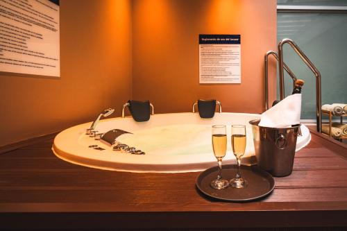 a bathroom with a sink and two glasses of champagne at Hampton By Hilton Cusco in Cusco