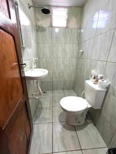 a bathroom with a toilet and a sink at Casa por do sol Flecheiras in Flecheiras