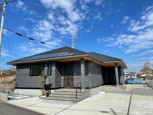 a house with a solar roof on top of it at Akikawa Tosima 1 プレミアム鉄骨 一棟貸切ヴィラ in Kumamoto
