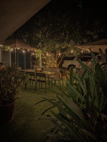 a patio with tables and umbrellas at night at Hotel San José in San José del Cabo