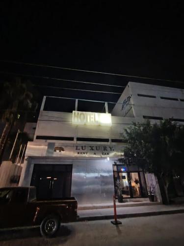 a hotel with a truck parked in front of it at Hotel San José in San José del Cabo