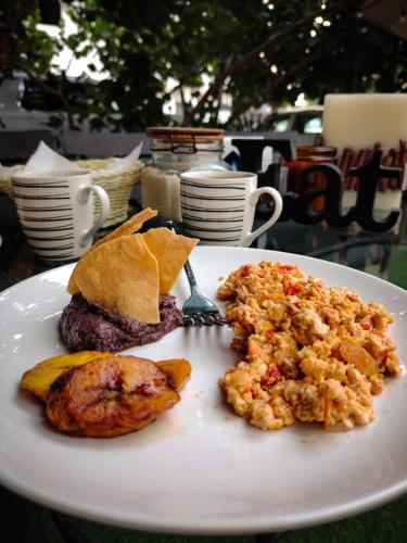 a white plate with food on a table at Hotel San José in San José del Cabo