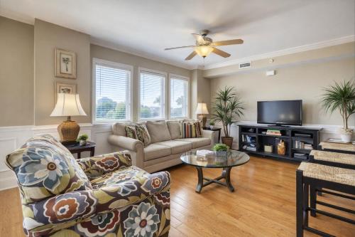 a living room with a couch and a tv at Captains Watch in Tybee Island