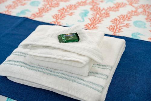 a pile of towels sitting on top of a bed at Cape Seacret in South Yarmouth
