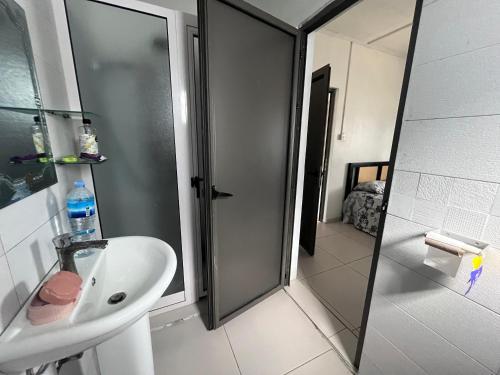 a bathroom with a shower and a sink and a toilet at Ashan Laksh Bungalow in Grande Rivière Sud Est