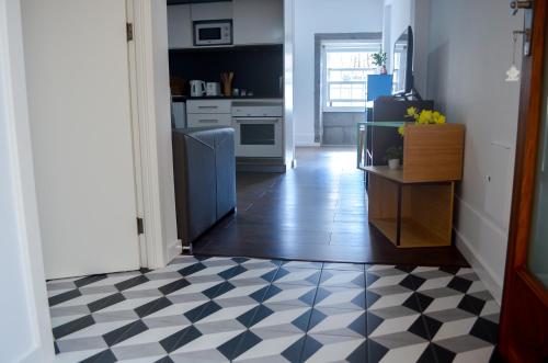 a kitchen with a black and white checkered floor at A Casa del Rei in Ribeira Grande