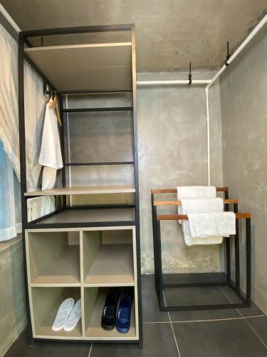 a walk in shower in a bathroom with towels at Namkhan Rivora Resort in Luang Prabang