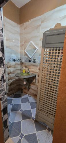 a bathroom with a shower with a table in it at Desert feet in Mhamid