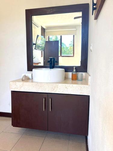 a bathroom with a sink and a mirror at Moro Apartments - Near the beach in Cancún