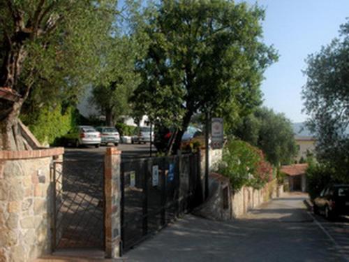 a fence on a street with cars parked on the road at Case Vacanze Morfeo in Palinuro