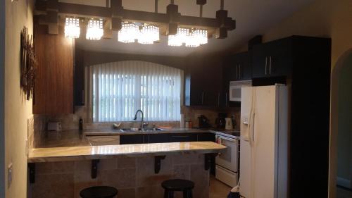 a kitchen with a sink and a refrigerator at Sunny Paradise in Cape Coral